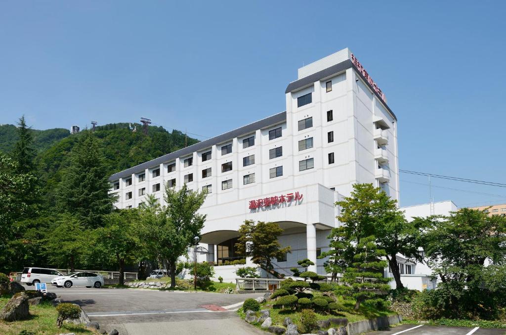Yuzawa Toei Hotel in Niigata, Japan — surrounded by snow-covered mountains and ski resorts, featuring hot springs and open-air baths in the Echigo-Yuzawa area