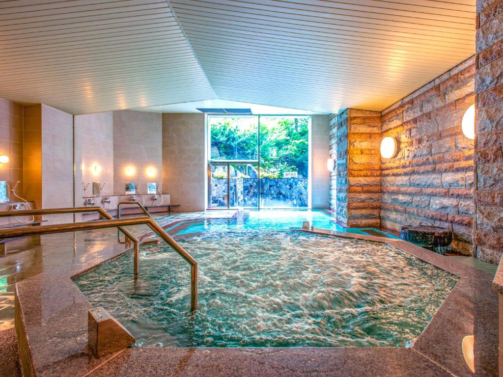 Yuzawa Toei Hotel in Niigata, Japan — surrounded by snow-covered mountains and ski resorts, featuring hot springs and open-air baths in the Echigo-Yuzawa area